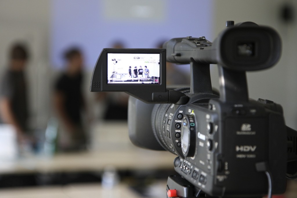 A picture describing camera recording. Showing a professional camera with active live view